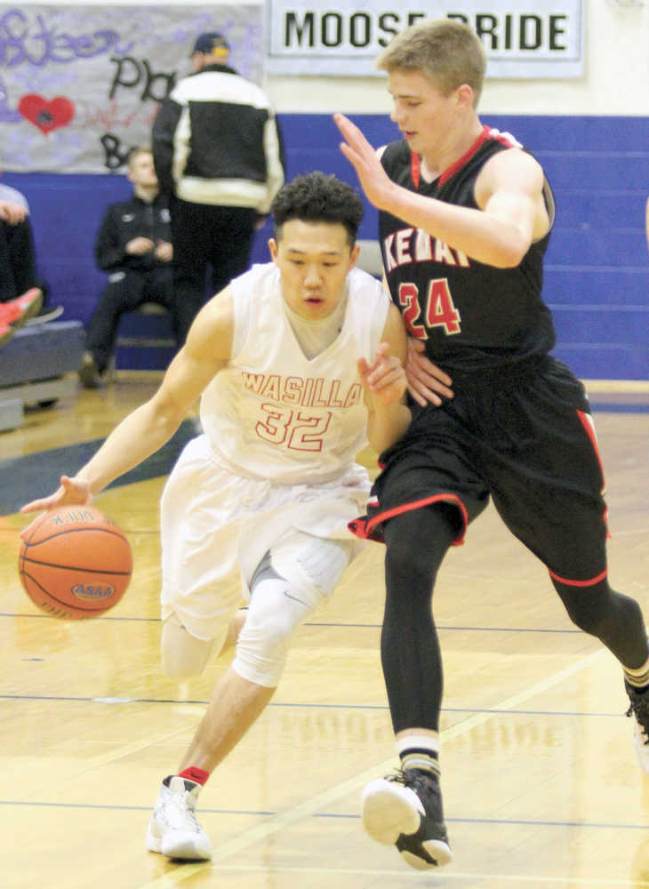 Wasilla senior Justin Lee works to get past Kenai's Garrett Fitt during a 57-50 overtime win over Kenai in the Northern Lights Conference Championships semifinals March 11, 2016, at Palmer High School.