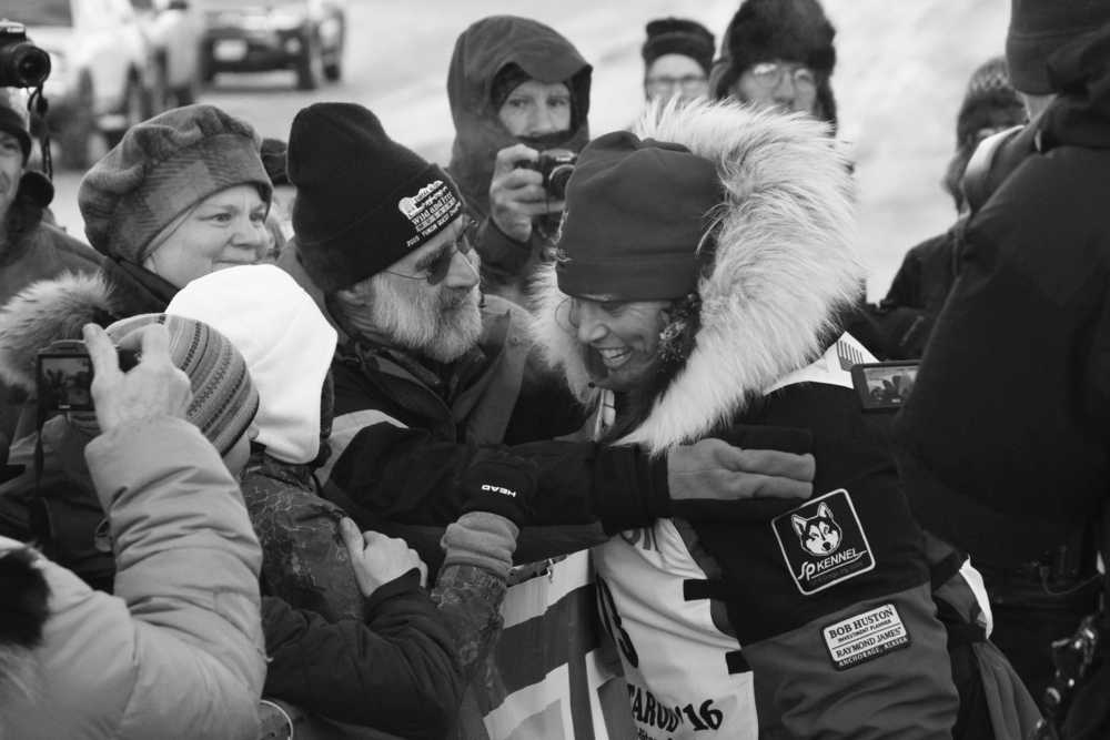AliyZirkle, right, greets fans at the finish line of the Iditarod Trail Sled Dog Race, Tuesday, March 15,  2016, in Nome, Alaska. Zirkle finished third. (AP Photo/Mark Thiessen)