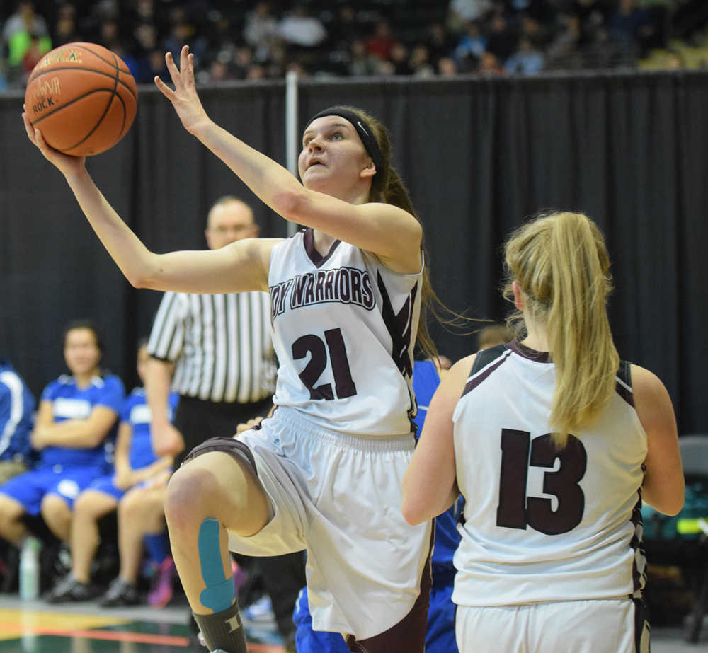 Photo by Joey Klecka/Peninsula Clarion Nikolaevsk senior Serafima Kalugin attempts a layup against Newhalen Wednesday at the Class 1A March Madness state tournament at the Alaska Airlines Arena in Anchorage. The Warriors pulled off a 46-42 win.