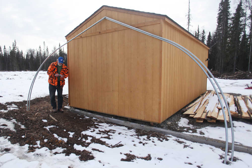 Photo by Kelly Sullivan/ Peninsula Clarion Steve Dahl takes a break from twisting and turning the metal frames of future high tunnels he will be installing on his property Tuesday, March 15, 2016, at Eagle Glade Farm LLC., in Nikiski, Alaska.