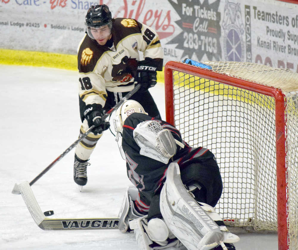 Photo by Jeff Helminiak/Peninsula Clarion Kenai River Brown Bears forward Collin Appleton drives the net, but is stopped by New Jersey Titans goalie Spencer Wright on Friday at the Soldotna Regional Sports Complex.