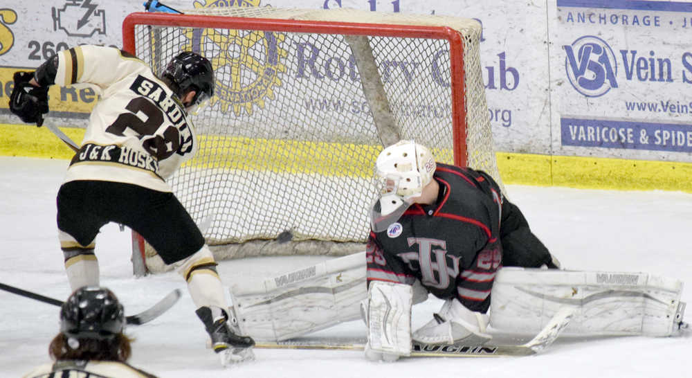 Photo by Jeff Helminiak/Peninsula Clarion Kenai River Brown Bears forward Joey Sardina scores a third-period, power-play goal on New Jersey Titans goalie Spencer Wright on Friday at the Soldotna Regional Sports Complex.