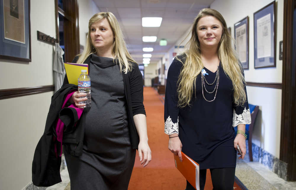 Amanda Metivier, left, and her foster daughter, Rachel Bedsworth, 19, walk to a meeting with a legislator in the Capitol on Thursday. Metivier is director of the nonprofit Facing Foster Care in Alaska. The pair are part of 22 members of foster families who came to Juneau this week to lobby legislators for more support for the foster care system.