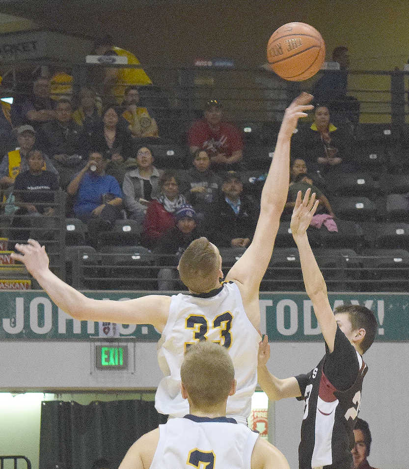 Photo by Joey Klecka/Peninsula Clarion Ninilchik junior Austin White (33) puts a block on Nikolaevsk junior Nikit Fefelov late in Saturday's Class 1A state championship boys game at the Alaska Airlines Center in Anchorage.