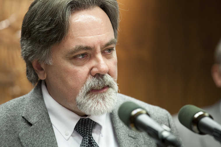 Alaska Department of Revenue Commissioner Randall Hoffbeck talks to reporters about the revenue forecast he released on Monday, March 21, 2016, in Juneau, Alaska. His department projects nearly $300 million less in revenue in the current fiscal year and $600 million next year due to continued low oil prices. (AP Photo/Rashah McChesney)