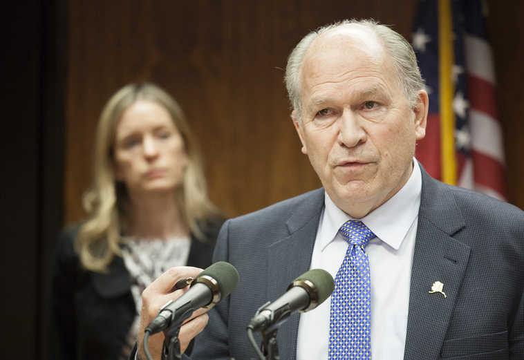 Alaska Gov. Bill Walker, with Assistant Attorney General Janell Hafner looking on, speaks during a news conference in Juneau, Alaska, about the U.S. Supreme Court decision siding with Alaska moose hunter John Sturgeon in his case against the National Park Service. The court on Tuesday unanimously threw out a lower court ruling that upheld enforcement of National Park Service rules banning the use of hovercraft on the river when it runs through the Yukon-Charley Rivers National Preserve. (AP Photo/Rashah McChesney)