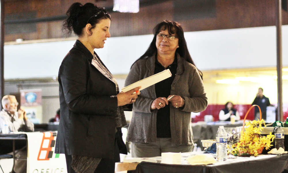 Job seeker Rachele Martin (left) talks to recruiter Julia Warwick of residental care provider ResCare at the Kenai Peninsula Job Fair on Wednesday, March 23 at Kenai's Old Carrs Mall. Jackie Garcia, business connection specialist at the Kenai Peninsula Job Center, said that over 600 people attended the fair to meet and speak with local employers.