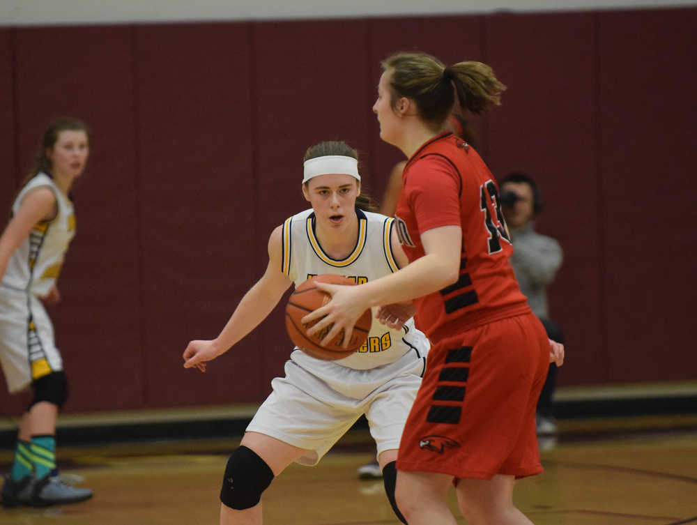 Photo by Joey Klecka/Peninsula Clarion Homer senior forward Madison Akers tracks the ball while defending Houston forward Aspen Ruth in Friday's semifinal game at the Southcentral Conference tournament at Grace Christian High School.