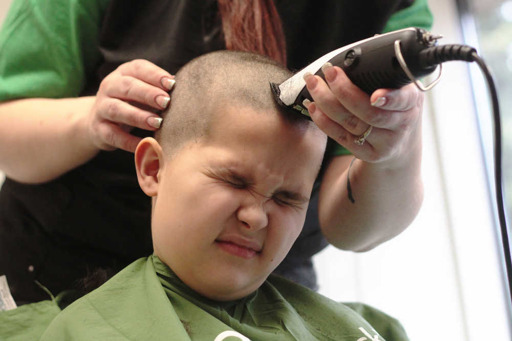 Brian Bliss finishes getting a shave from barber Crystal Stonecipher of the Hey Good Lookin' Salon at a St. Baldrick's head-shaving fundraiser at Kenai Peninsula College on Thursday, March 24. Over 17 people had their heads shaved in exchange for donations to St. Baldrick's Foundation, a research charity for pediatric cancer.