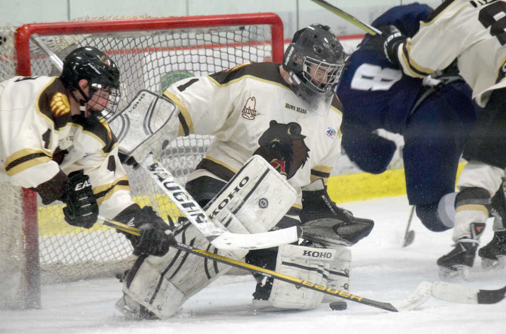 Photo by Jeff Helminiak/Peninsula Clarion Kenai River Brown Bears defenseman Jake Hartje (4) and goalie Nick Nast successfully keep the puck from going in the net Friday, March 25, 2016, against the Wilkes-Barre/Scranton Knights at the Soldotna Regional Sports Complex.