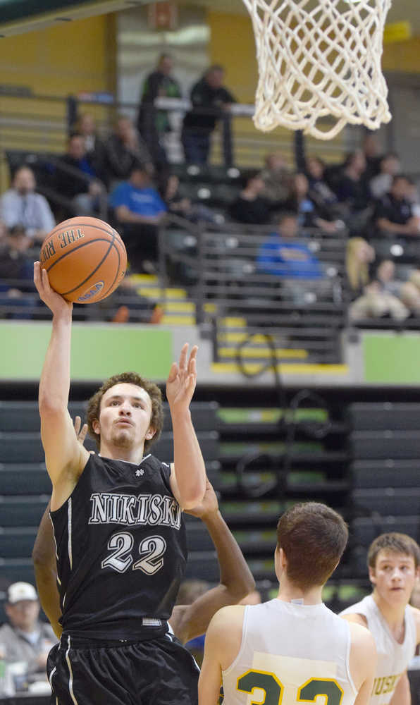 Photo by Joey Klecka/Peninsula Clarion Nikiski senior Hunter Holloway moves in for a layup against Delta Junction in Friday's Class 3A boys state tournament consolation semifinal contest at the Alaska Airlines Center in Anchorage.