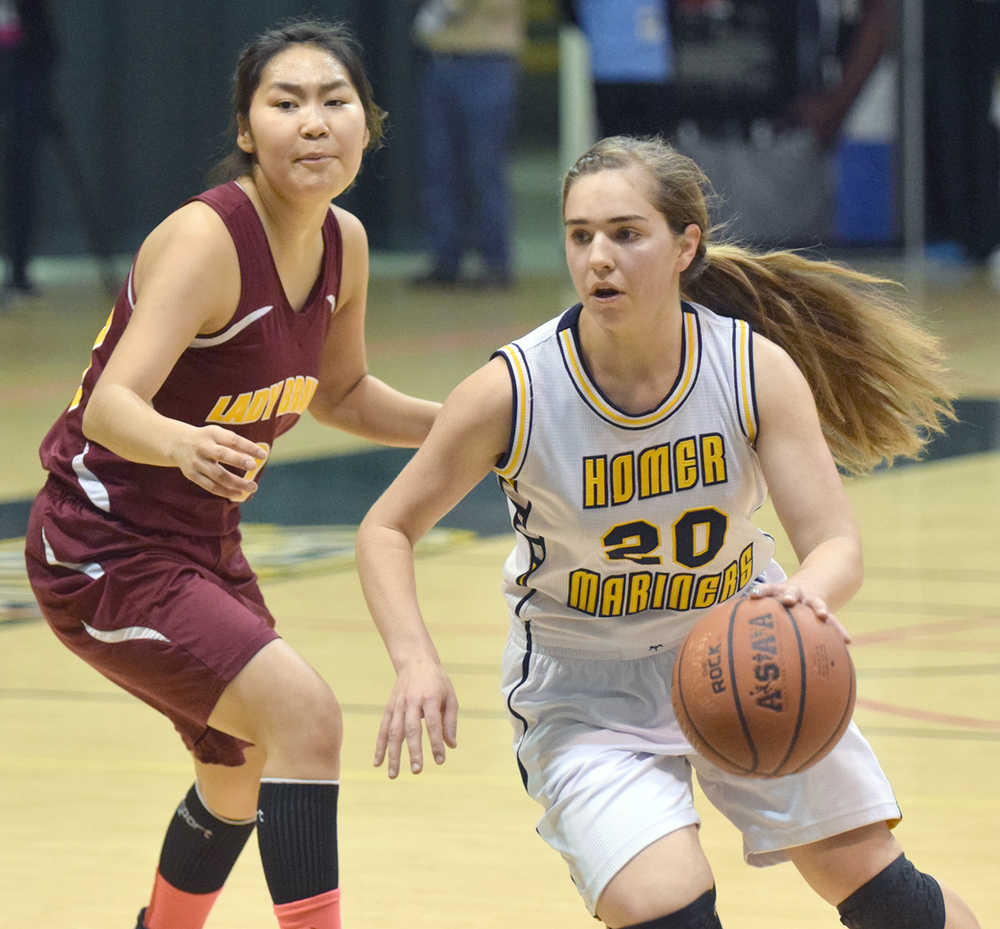 Photo by Joey Klecka/Peninsula Clarion Homer senior Aurora Waclawski dribbles around Mt. Edgecumbe defender Julie Amaktoolik in Friday's Class 3A girls state semifinal at the Alaska Airlines Center in Anchorage.