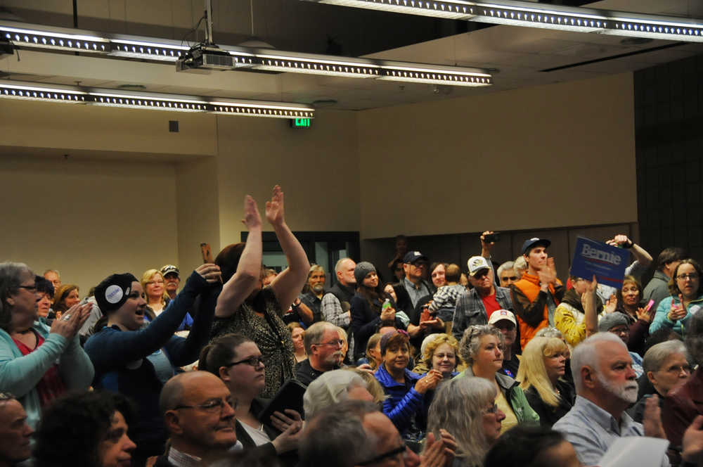 Photo by Elizabeth Earl/Peninsula Clarion Bernie Sanders supporters stood to cheer during the Democratic caucus Saturday morning at Kenai's Challenger Learning Center. Approximately 250 people from Districts 29, 30 and 31 turned out to show support for the candidates.