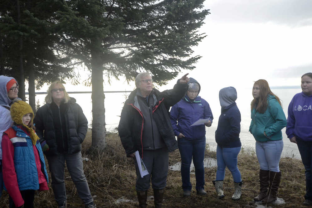 Photo by Megan Pacer/Peninsula Clarion Kenaitze Indian Tribe members, students and Kenai Peninsula College faculty make their way through the woods to the site of Kalifornsky Village on Thursday, March 24, 2016 off of Kalifornsky Beach Road in Alaska.