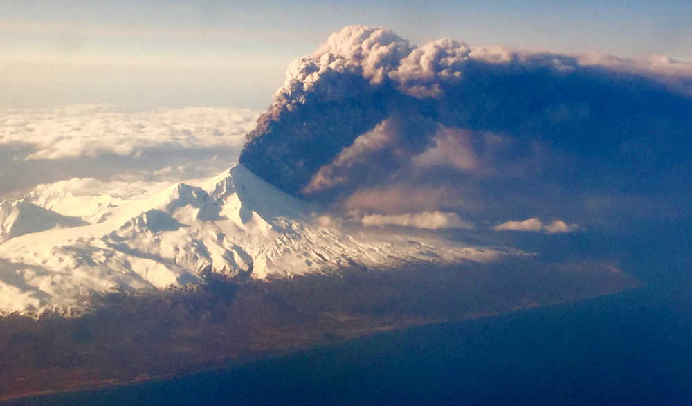 In this Sunday, March 27, 2016, photo, Pavlof Volcano, one of Alaska's most active volcanoes, erupts, sending a plume of volcanic ash into the air. The Alaska Volcano Observatory says activity continued Monday. Pavlof Volcano is 625 miles southwest of Anchorage on the Alaska Peninsula, the finger of land that sticks out from mainland Alaska toward the Aleutian Islands. (Colt Snapp via AP) MANDATORY CREDIT