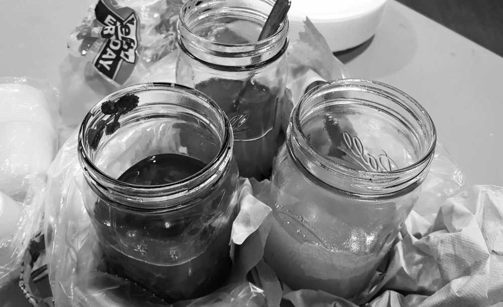 This Feb. 1, 2016 photo provided by Val Kreil, shows jars of seal oil served during a potluck at a nursing home in Kotzebue, Alaska. The Alaska Native organization that operates the home is hoping to regularly serve its nursing home residents the nutrient-rich oil, a traditional staple that's banned in public settings because of its high risk for botulism if not properly processed. (Val Kreil via AP)