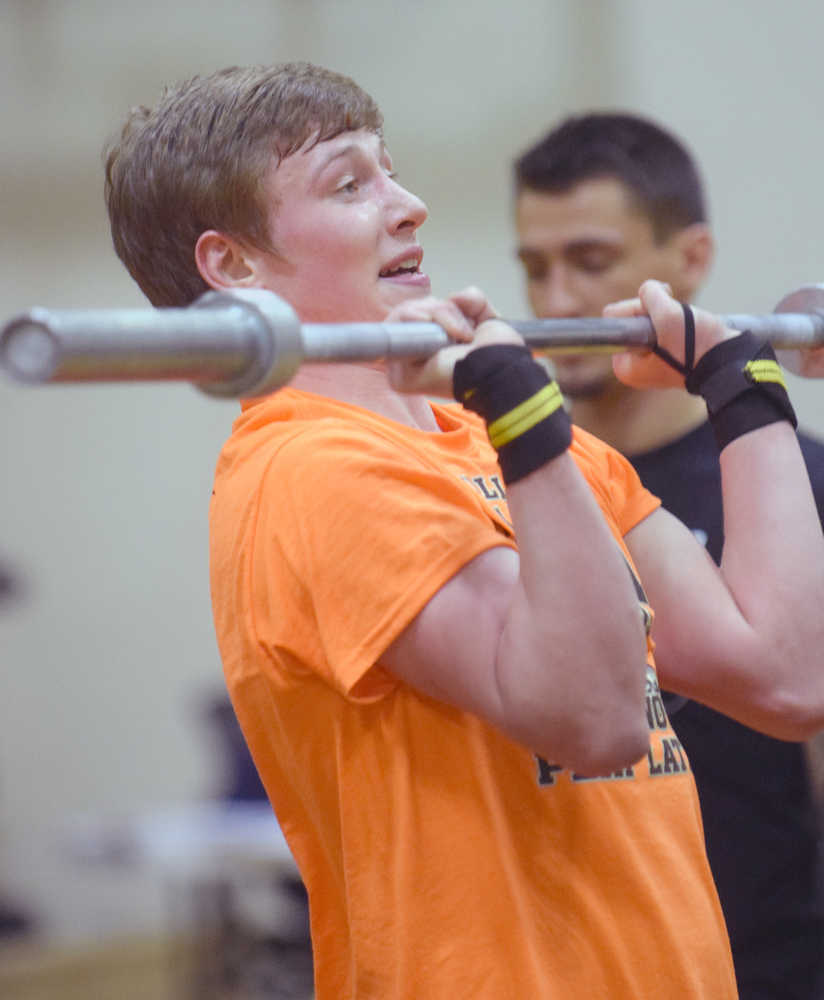 Photo by Jeff Helminiak/Peninsula Clarion Nikiski senior Dylan Broussard does a push press on the way to winning the Fight Gone Bad event at the Speed and Strength Training competition Wednesday at Nikiski High School.