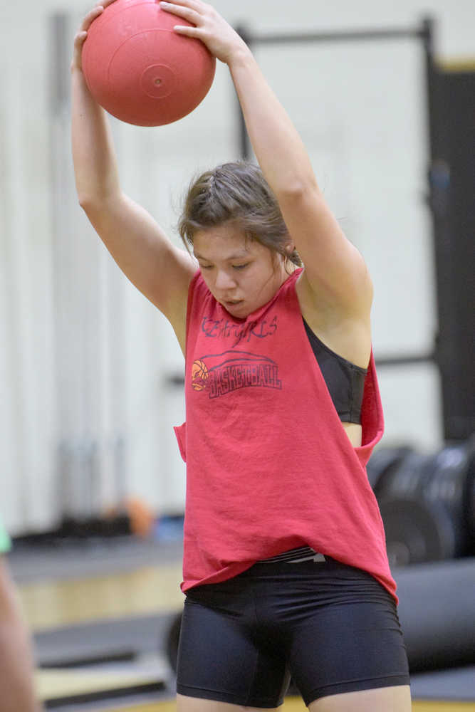 Photo by Jeff Helminiak/Peninsula Clarion Kenai Central junior Julianne Wilson does the ball slam en route to winning the Fight Gone Bad at the Speed and Strength Training competition Wednesday at Nikiski High School.
