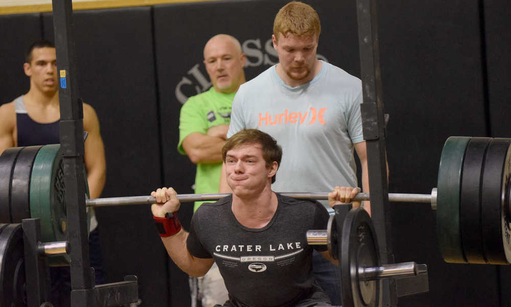 Photo by Jeff Helminiak/Peninsula Clarion Soldotna junior Austin Schrader competes in the back squat in the Speed and Strength Training competition Wednesday at Nikiski High School.