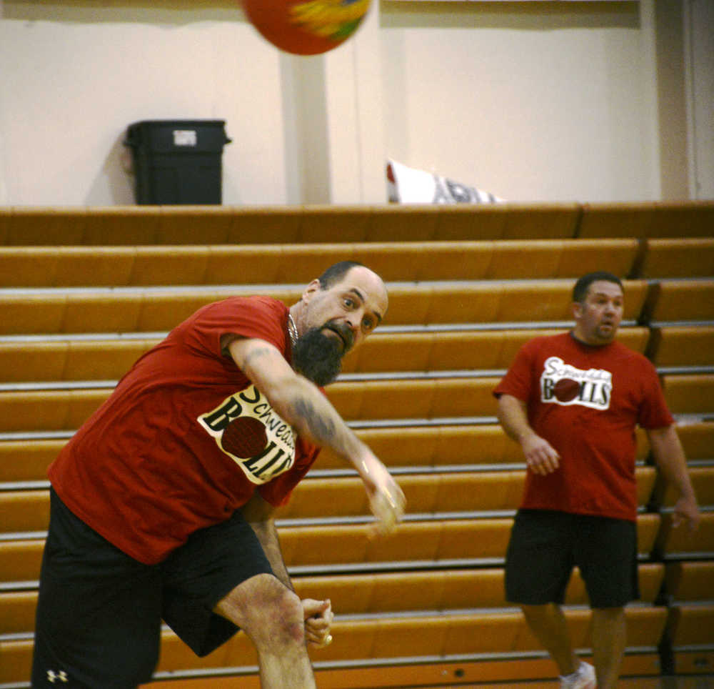 Travis Burnett of the Magnum Motors dodgeball team flings a ball at an opponent, with teammate James Dye in the background, during the Young Professionals Dodgeball tournament on Saturday, March 26 at the Kenai Central High School gymnasium.