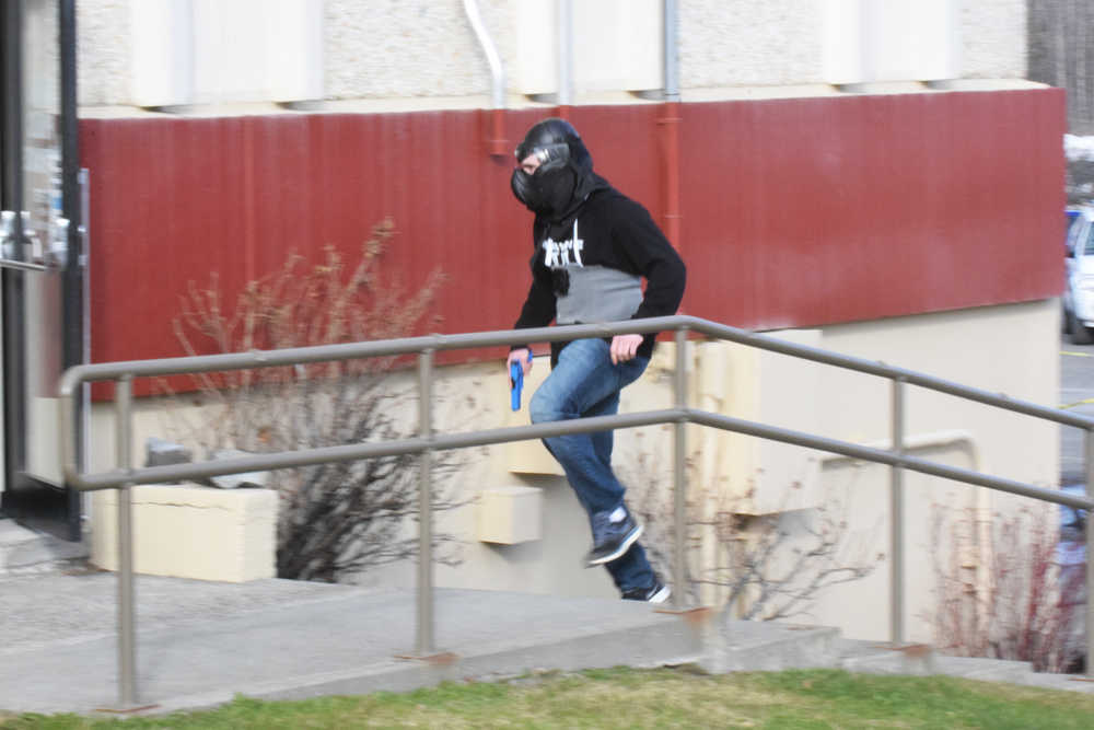 Photo by Megan Pacer/Peninsula Clarion Koebryn Mlynarik enters the Kenai Peninsula Borough building during an active shooter simulation as part of this year's Alaska Shield exercise on Thursday, March 31, 2016 in Soldotna, Alaska.