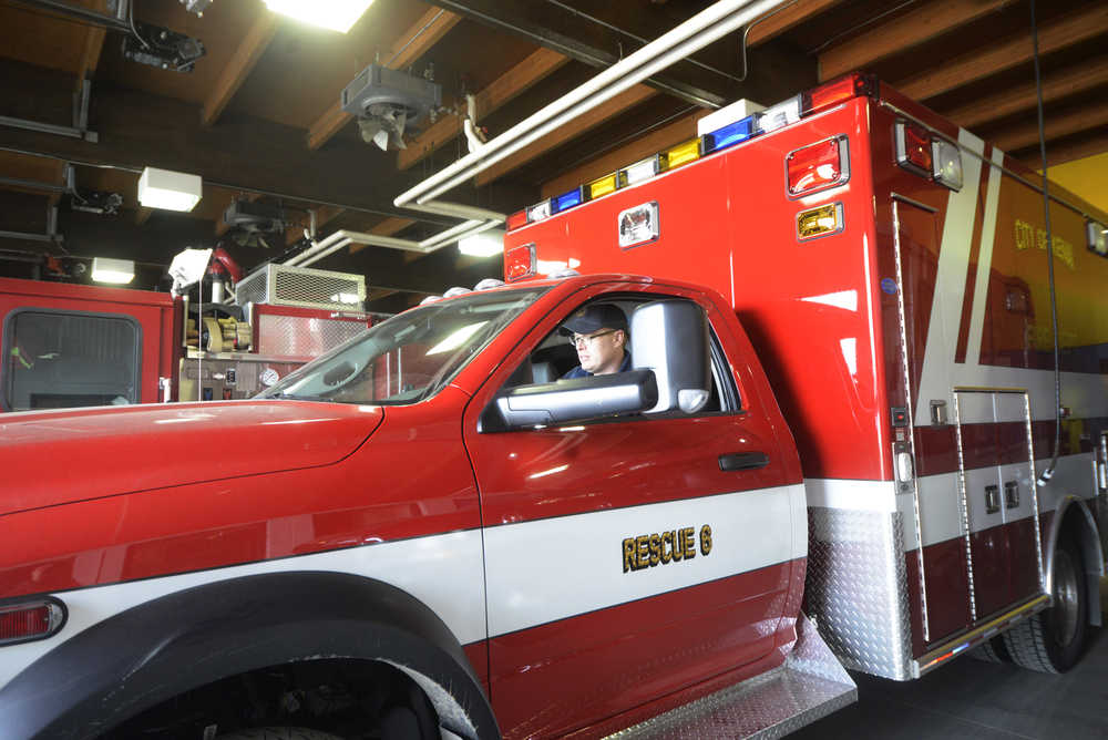 Photo by Megan Pacer/Peninsula Clarion A member of Kenai Fire pulls the department's new ambulance, Rescue 6, out of the garage on Monday, April 4, 2016 at the Kenai Fire Department in Kenai, Alaska. Kenai Fire Chief Jeff Tucker said the ambulance was budgeted for and will allow the department to have two ambulances in service at a time with one on reserve in case of an emergency. It comes with a gas engine, which he said will be easier for local mechanics to work on compared to the other vehicles which use diesel.