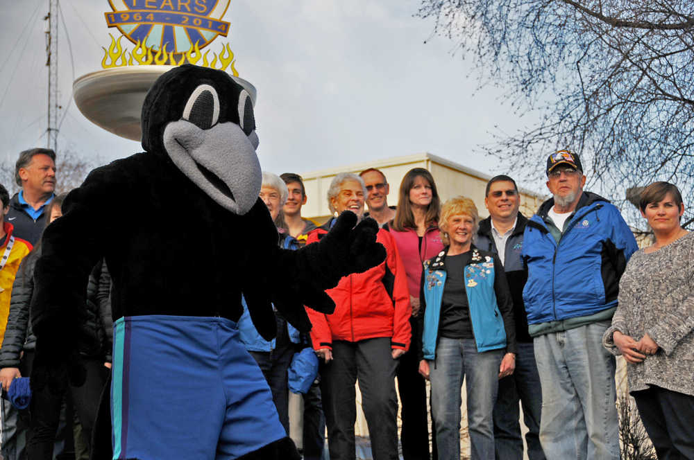 Photo by Elizabeth Earl/Peninsula Clarion Rascal the Raven, the mascot for the 2006 Arctic Winter Games, posed with former organizers and participants in front of the George A. Navarre Kenai Peninsula Borough building in Soldotna, Alaska on Tuesday, April 5, 2016. The borough assembly designed Tuesday a "day of celebration" in commemoration of the 10-year anniversary of the Arctic Winter Games being held on the Kenai Peninsula.