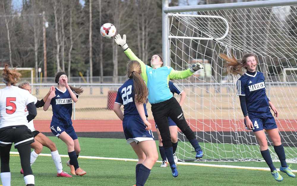 Photo by Joey Klecka/Peninsula Clarion Homer goalkeeper Sam Draves stretches out for the save in a regular season matchup Wednesday evening against Kenai Central.