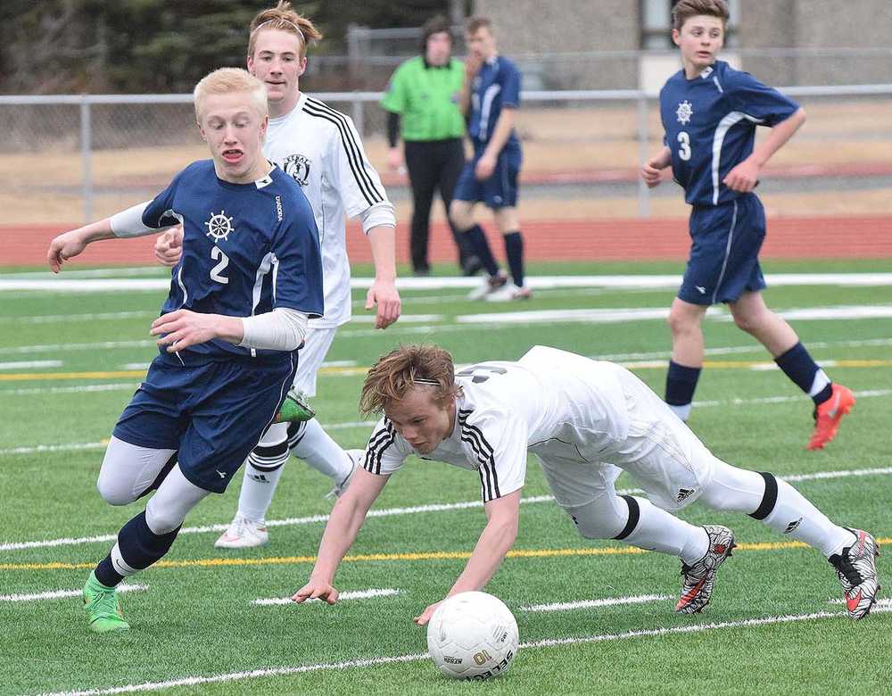 Photo by Joey Klecka/Peninsula Clarion Homer sophomore Charles Rohr (2) wins a battle for the ball over Kenai freshman Connor Felchle in a regular season matchup Wednesday evening at Kenai Central High School.