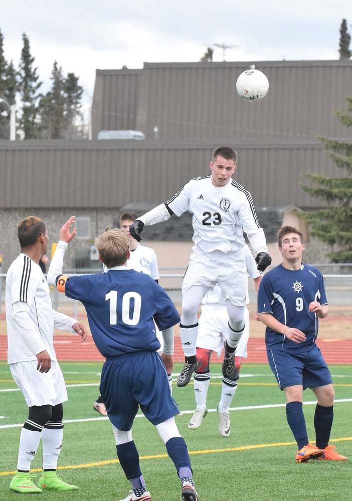 Photo by Joey Klecka/Peninsula Clarion Kenai Central sophomore Zack Tuttle (23) heads the ball amid a pack of players Wednesday against Homer at Ed Hollier Field in Kenai. The Kardinals defeated the Mariners 4-0.