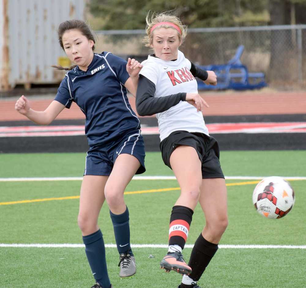 Photo by Jeff Helminiak/Peninsula Clarion Eagle River's Dylan Johnson battles for the ball with Kenai Central's Ean Atchley while the Kardinals' Rykker Riddall watches Friday, April 8, 2016, at Kenai Central High School.