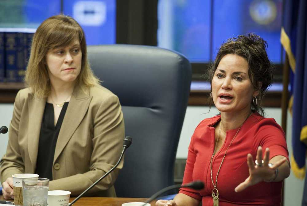 Sen. Mia Costello, R-Anchorage, left, watches as colleague Sen. Lesil McGuire, right, discusses the state's tax credit program for oil companies during a Senate Majority news conference on Monday, April 11, 2016, in Juneau, Alaska. A planned Sunday vote on a bill that is designed to gradually reduce the $825 million in credits to companies with no tax liabilities stalled on the House floor. Republican House majority members have delayed committee meetings Monday as they meet to hammer out a consensus on House Bill 247. (AP Photo/Rashah McChesney)