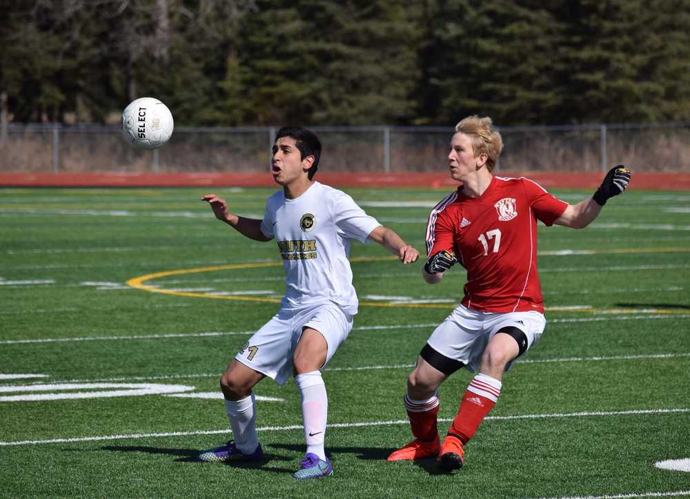 Photo by Joey Klecka/Peninsula Clarion South Anchorage's Patricio Moyano protects the ball from Kenai Central defender Karl Danielson (17) Saturday at Ed Hollier Field in Kenai.