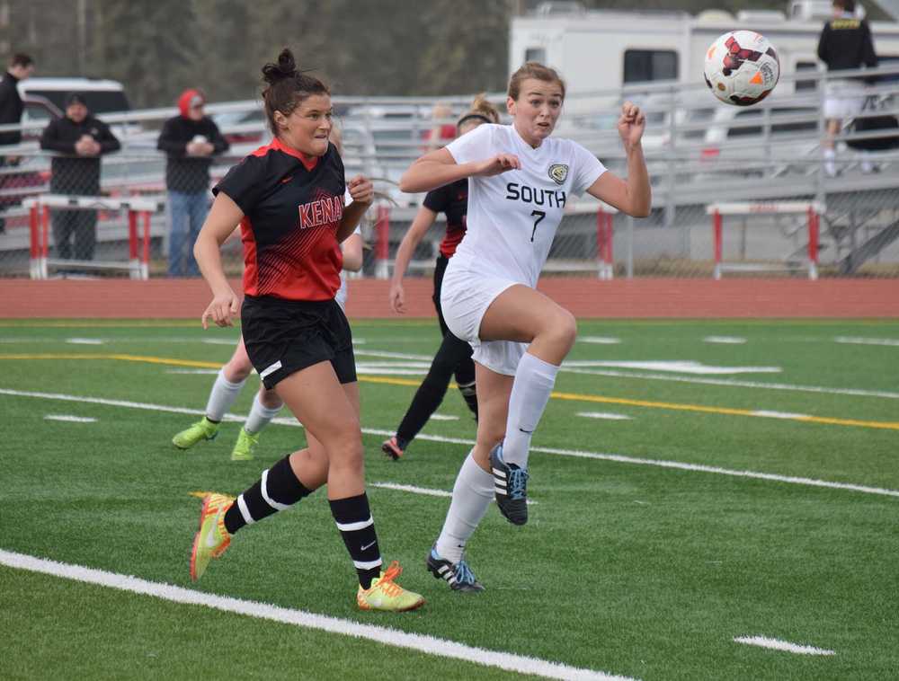 Photo by Joey Klecka/Peninsula Clarion Kenai Central defender Sarah Every (left) eyes the ball along with South Anchorage's Isabel Evans Saturday at Ed Hollier Field in Kenai.