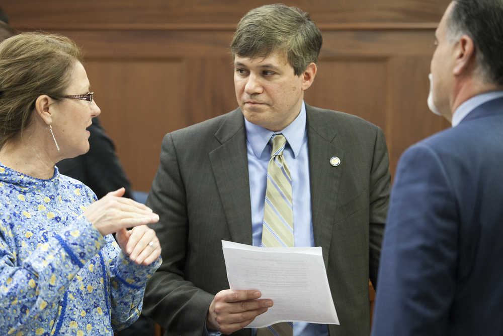 Sens. Anna MacKinnon, R-Eagle River , Bill Wielechowski, D-Anchorage, and Peter Micciche, R-Soldotna discuss an amendment to a tax credit bill benefiting a gas-to-liquid natural gas processing facility on the Kenai Peninsula on Sunday, April 17, 2016, in Juneau, Alaska. Wielechowski suggesting capping the credit, MacKinnon and Micciche did not support the idea and ultimately prevailed with a 15-5 vote on the Senate floor. (AP Photo/Rashah McChesney)