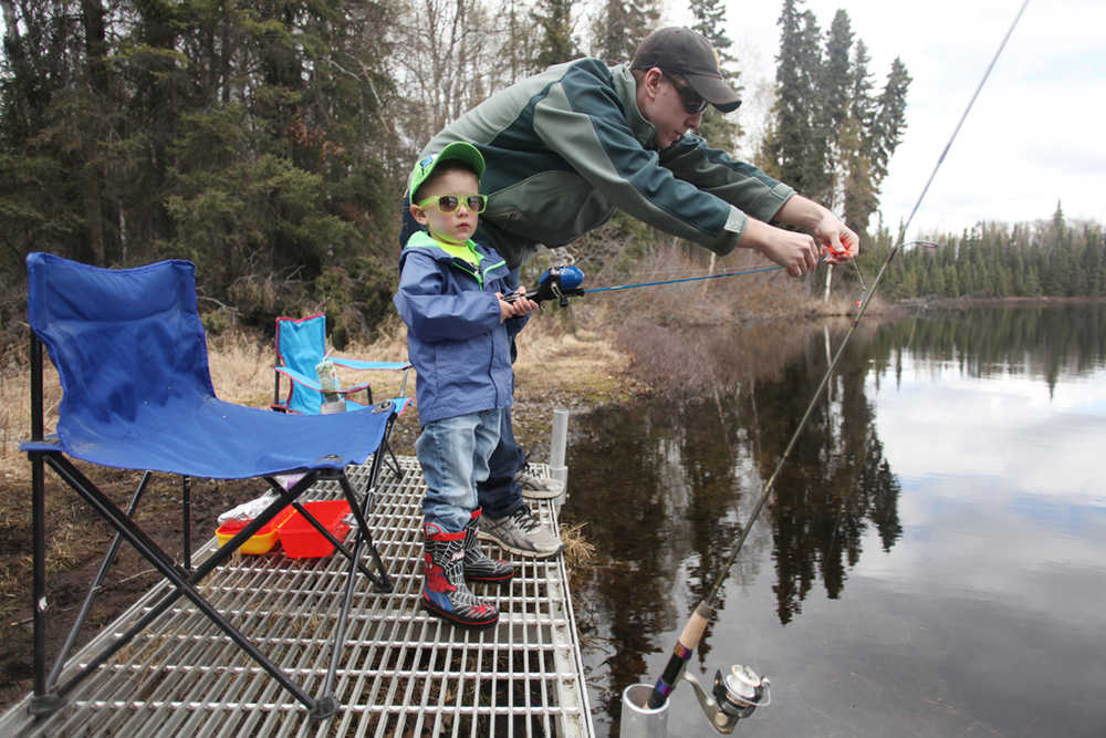 Photo by Kelly Sullivan/ Peninsula Clarion (Not pictured) Aimee, (left) Rudy and Sam Zulkanycz get in some early spring fishing Monday, April 18, 2016, at Loon Lake in Soldotna, Alaska. Sam said the quiet spot is a family favorite, especially when the sun is out and there is no one else on the joining them on the perimeter. "They aren't the biggest and best fish by that's okay," he said.