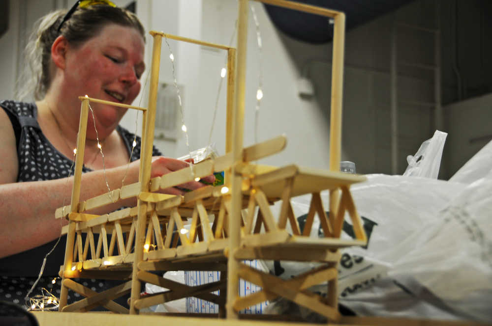 Photo by Elizabeth Earl/Peninsula Clarion Holly West, a senior at Kenai Peninsula College, works on her project at the college's 3D design studio on Friday, April 15, 2016. West said her project, building the Bay Bridge from popsicle sticks, is part of a project conveying the connection her uncle had traveling back and forth from China for work.