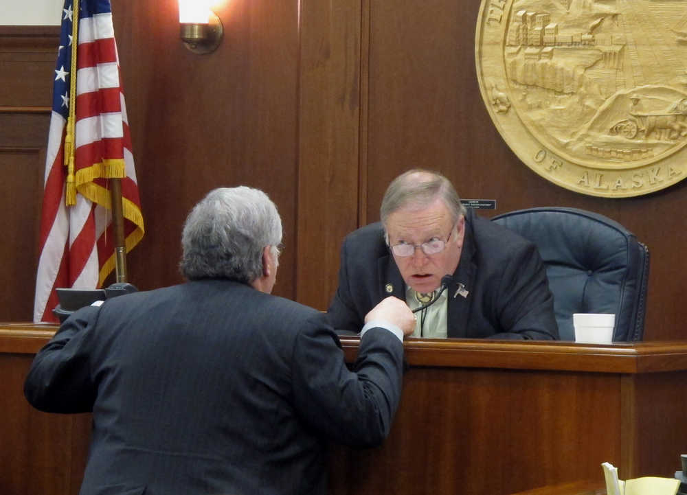 Alaska state House Speaker Mike Chenault leans forward to speak with Rep. Kurt Olson during a break in an evening floor session on Sunday, April 17, 2016, in Juneau, Alaska. (AP Photo/Becky Bohrer)