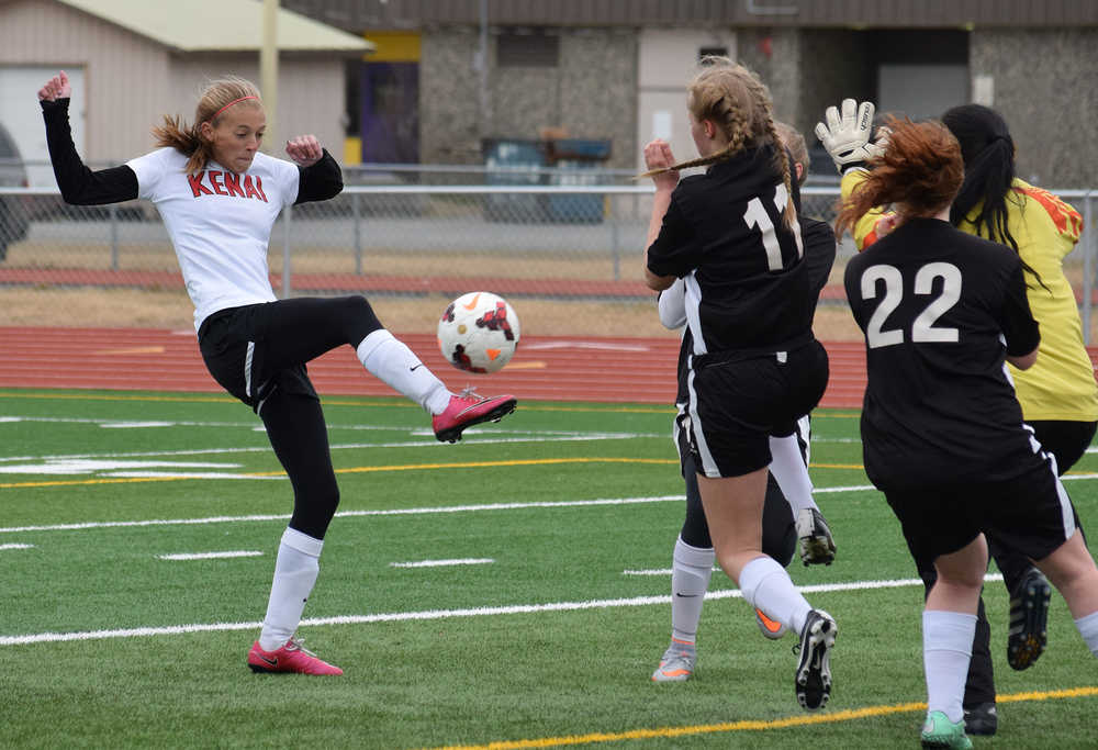 Photo by Joey Klecka/Peninsula Clarion Kenai Central striker Samantha Morse (center, white) taps the ball over a crowd of Nikiski defenders for a goal Tuesday evening at Ed Hollier Field in Kenai.