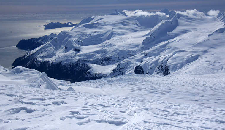 This Friday, April 8, 2016, photo provided by Jenny Neyman shows the view from the Harding Ice Field south of Seward on the Kenai Peninsula at about 5,000 feet elevation, overlooking Aialik Glacier, in Kenai Fjords National Park, Alaska. Two skiers stranded for four nights on the Alaska ice field braved cold and hunger but also claustrophobia as the ceiling of snow cave they dug for shelter sagged close to their faces. Chris Hanna and Jenny Neyman say they thought the cave Hanna tunneled under 4 feet of snow might collapse before rescuers could reach them. (Jenny Neyman via AP)