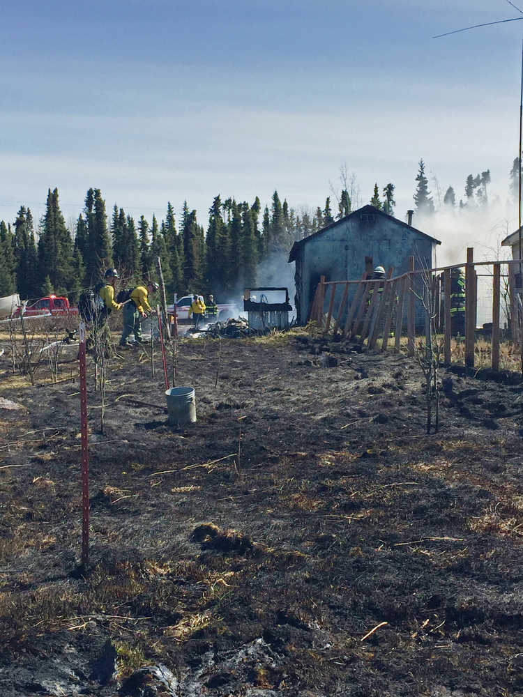 Photo by Megan Pacer/Peninsula Clarion Kenai Fire Department firefighters work to put out a structure fire on North Dogwood Road on Thursday, April 22, 2016.