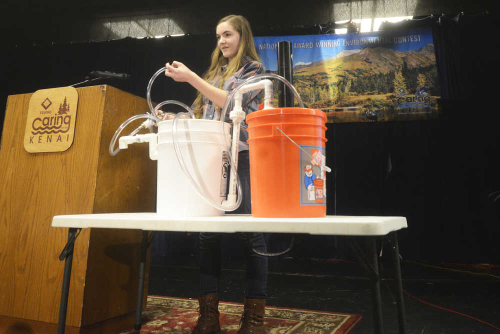 Photo by Megan Pacer/Peninsula Clarion Freshman Victoria Giles from Soldotna Prep demonstrates her project that converts organic matter into energy before a panel of judges for this year's Caring for the Kenai oral presentations Thursday, April 21, 2016 at Kenai Central High School in Kenai, Alaska. From more than 300 applicants, 12 students were chosen to present their projects in a final round, after which six runners up won fixed prizes and another six won prizes varying from $550-$1,600.