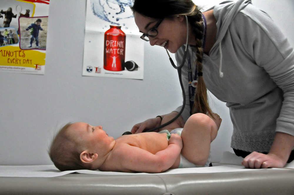 Photo by Elizabeth Earl/Peninsula Clarion Sherra Pritchard, a public health nurse at the Kenai Public Health Center in Kenai, Alaska, listens for a heartbeat on Jude Stillwell, 6 months, during a wellness check on Wednesday, April 20, 2016.
