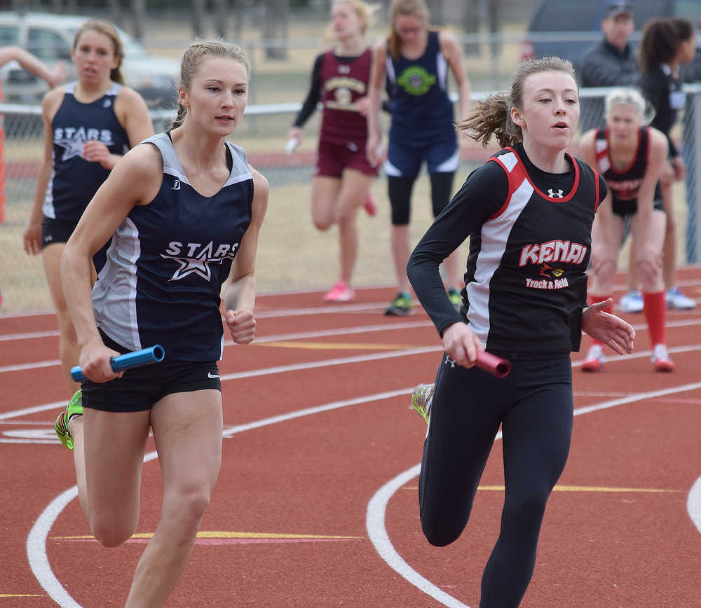 Photo by Joey Klecka/Peninsula Clarion Soldotna senior Daisy Nelson (left) and Kenai Central sophomore Melia Harding duke it out on the final leg of the girls 800-meter relay Saturday afternoon at Kenai Central High School.