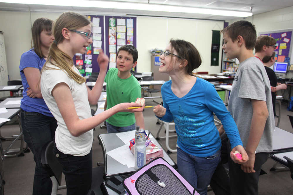 Photo by Kelly Sullivan/ Peninsula Clarion Members of the math club were asked the probability of pulling various shapes and cookie colors from the bag before advisor David Thomas agreed to hand over the goods Thursday, April 21, 2016, at the school in Kenai, Alaska.