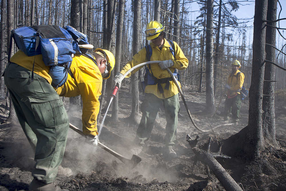 Photo by Rashah McChesney/Peninsula Clarion  In this June 18, 2015 Patrick "PBun" Madros and Fred Alexi, both of Kaltag work to put out a hot spot off of Kamloops Road near the Kenai Keys in Sterling, Alaska. Last year's Card Street fire burned about 9,000 acres.