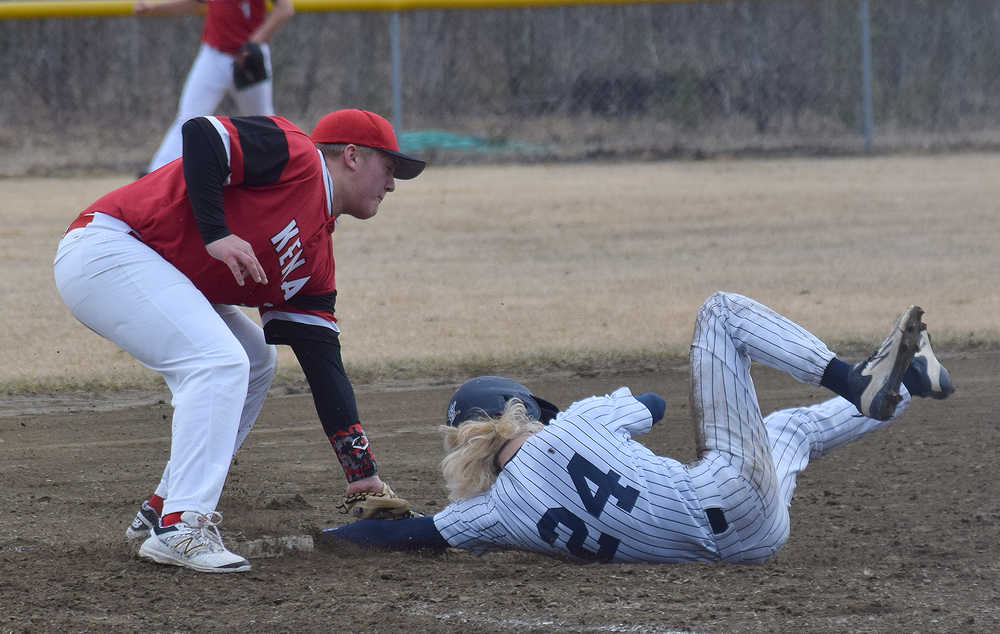 Photo by Joey Klecka/Peninsula Clarion Soldotna senior Kenny Griffin (24) steals third base just before Kenai Central third baseman Connor Jones tags him Tuesday at the Soldotna ball fields.