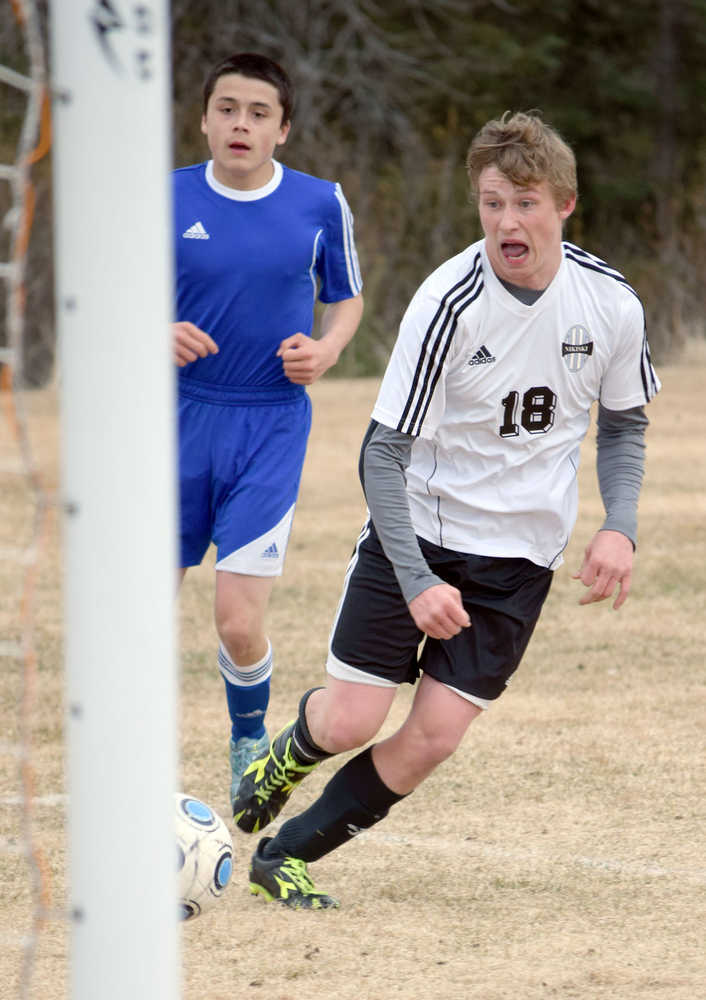 Photo by Jeff Helminiak/Peninsula Clarion Nikiski's Dylan Broussard breaks in on goal in front of Kodiak's Walter Brewer on Tuesday at Nikiski High School.