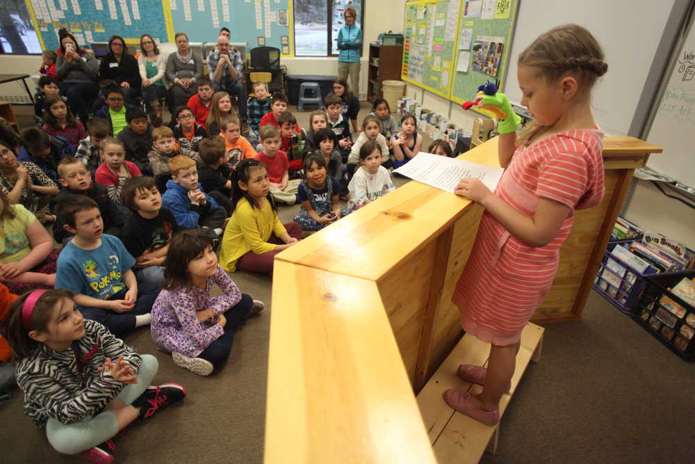 Photo by Kelly Sullivan/ Peninsula Clarion  Chloe Wendelschafer reads her Frog Important Poem Thursday, April 28, 2016, at Kalifornsky Beach Elementary, in Soldotna, Alaska.