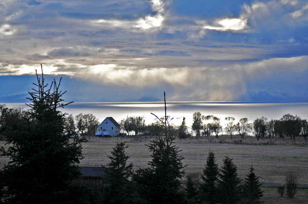 Photo by Elizabeth Earl/Peninsula Clarion Frank and Mary Ferguson can see three volcanoes on the west side of Cook Inlet from their back porch near Clam Gulch, Alaska, seen on Friday, April 29, 2016.